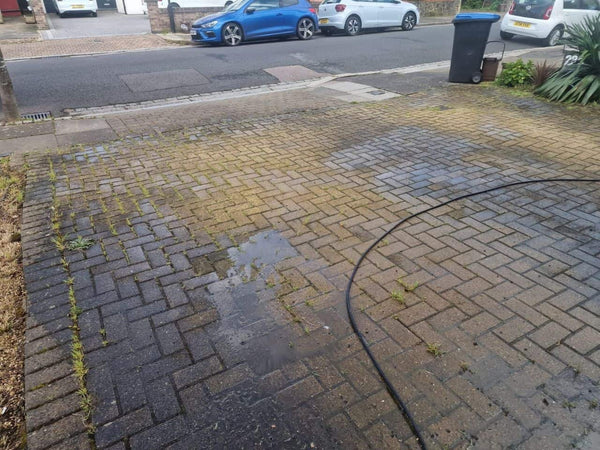 Before — Block paving covered in moss and weeds